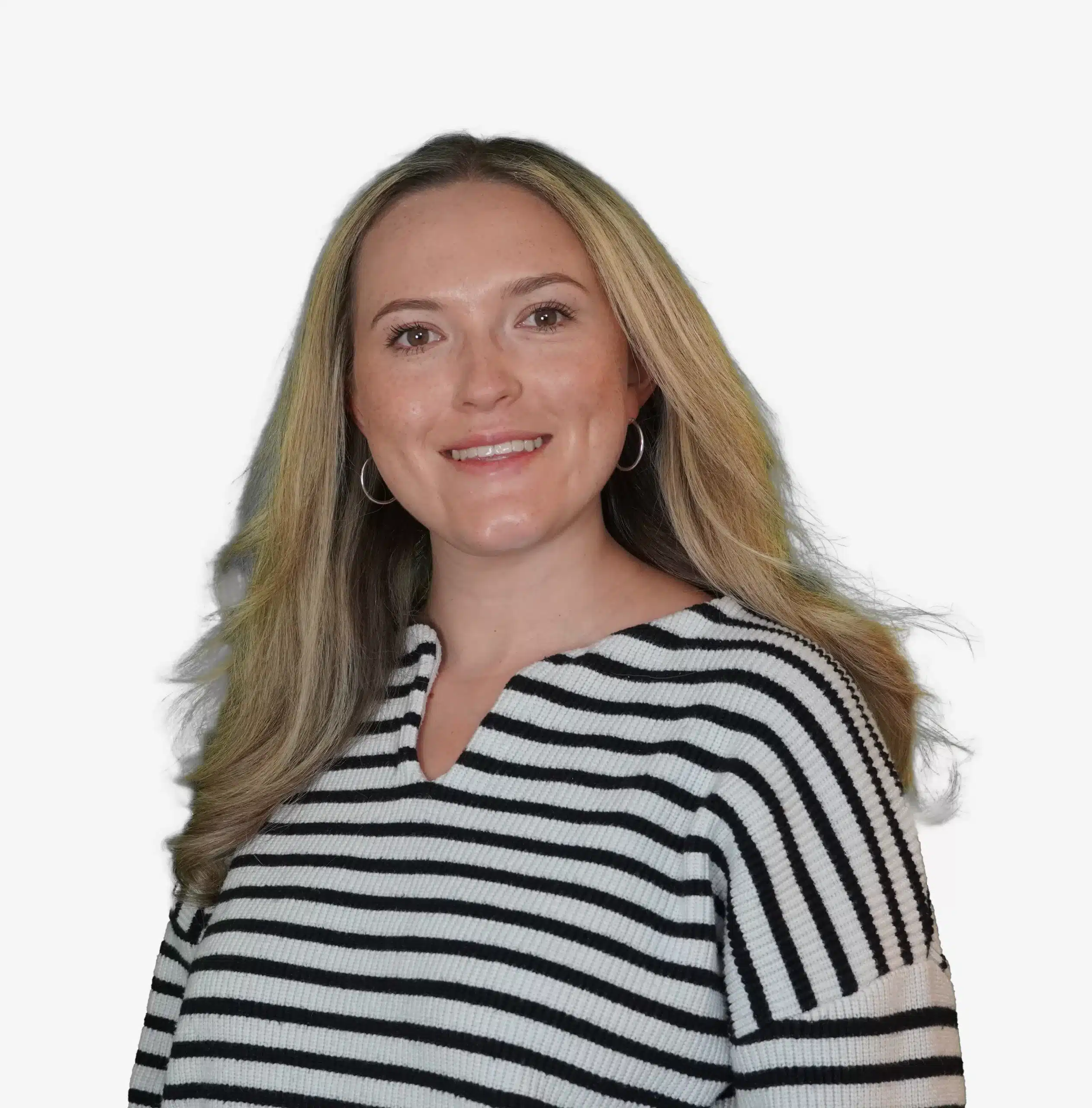 A woman with long blonde hair, wearing a black and white striped sweater and hoop earrings, is smiling confidently, embodying the vitality often seen in those benefiting from pulmonary rehab, against a simple white background.