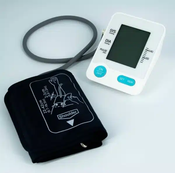 The Bluetooth Enabled Digital Blood Pressure Cuff & Monitor for Home Use features a gray rubber tube, black cuff with arm placement instructions, and buttons for power, settings, and memory. Its screen displays systolic, diastolic, and pulse rates.