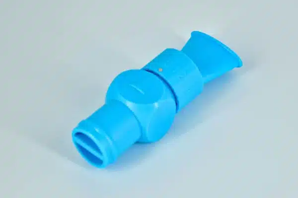 The Delta-V All-In-One Lung Trainer is a blue plastic toy whistle featuring a spherical center and tapered ends, with one end displaying a numbered dial, placed on a light gray surface.