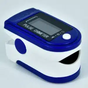 A blue and white Fingertip Pulse Oximeter, Blood Oxygen Saturation Monitor (SpO2) with a digital display is shown on a light surface. It features a "PUSH" button on top, and "PULSE OXIMETER" written beneath the screen.